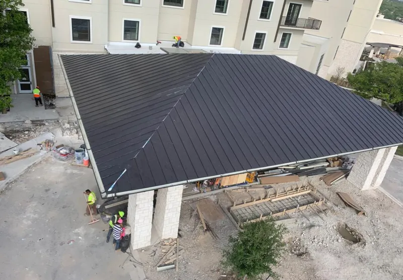 Metal roofing installation team working on a commercial building in San Dimas